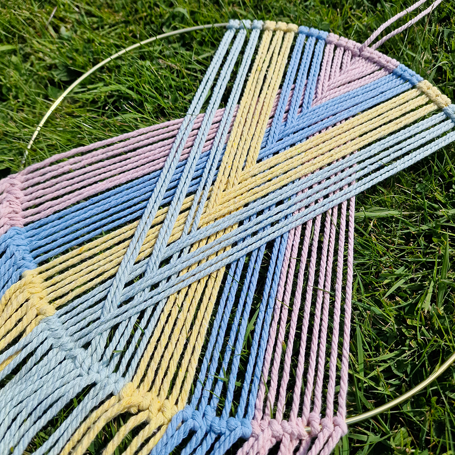 Handcrafted geometric macramé wall hanging in Pastel colours (Pink, blue, yellow and green with beads for boho décor