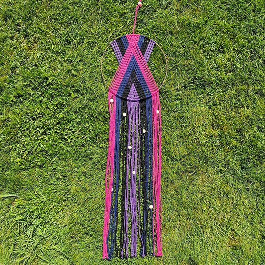 Handcrafted geometric macramé wall hanging in purple, pink, blue and black colours with beads for boho décor