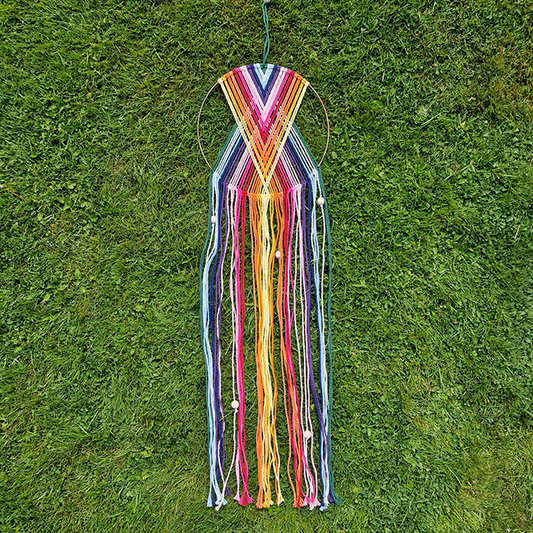 Handcrafted geometric macramé wall hanging in rainbow colours (Red, Yellow, Orange and Green) with beads for boho décor