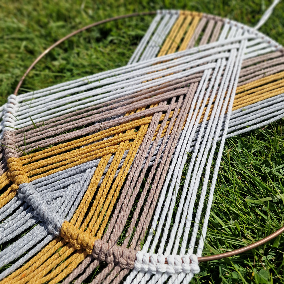 Handcrafted geometric macramé wall hanging in Neutral colours (Grey, Yellow, Beige and Cream) with beads for boho décor