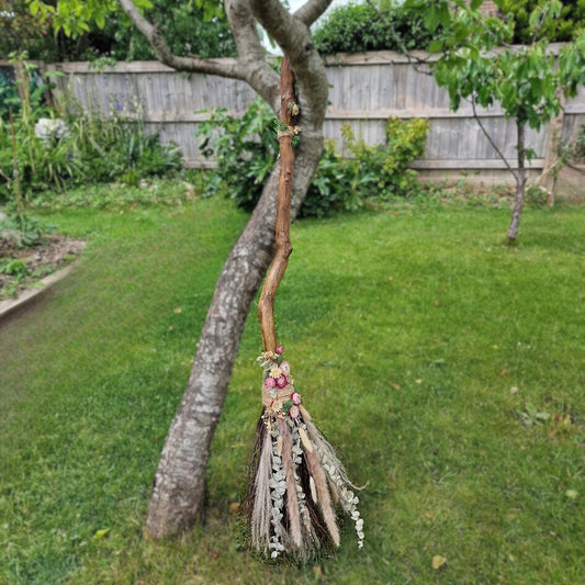 Rustic handmade Pagan witch’s broom with Citrine crystal in the handle, adorned with dried flowers, eucalyptus, and natural twigs.