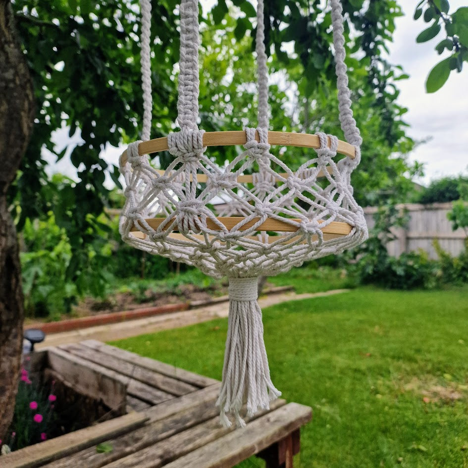 Triple-layered macramé plant hanger or vegetable holder made from natural cotton rope for boho home décor