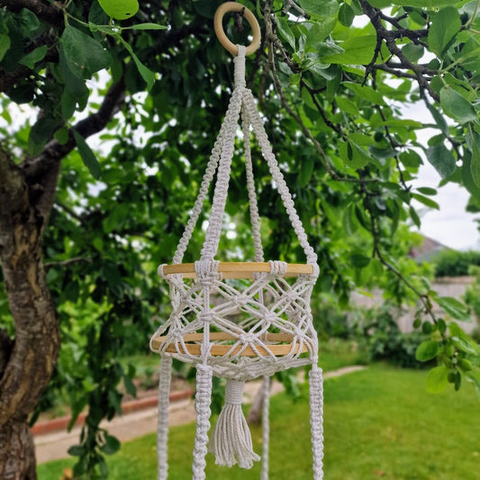 Triple-layered macramé plant hanger or vegetable holder made from natural cotton rope for boho home décor