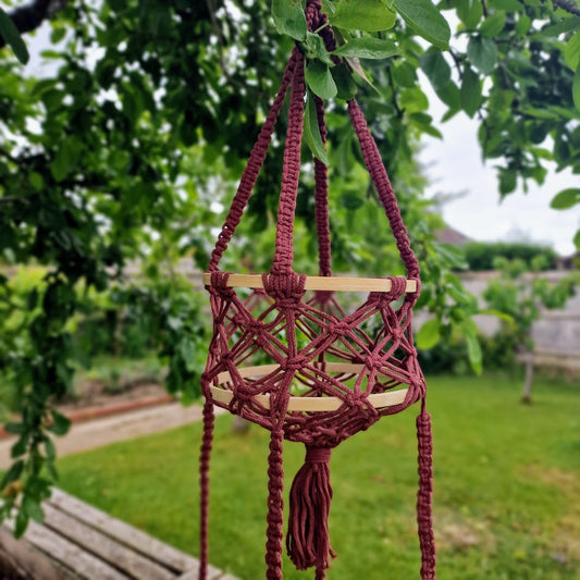 Triple-layered macramé plant hanger or vegetable holder made from natural cotton rope for boho home décor
