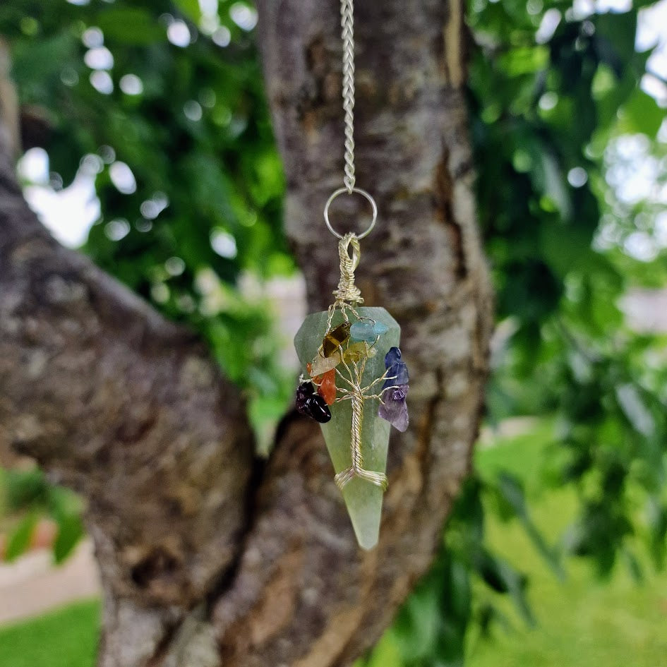 green crystal pendulum with wire-wrapped Tree of Life and chakra stones for energy work