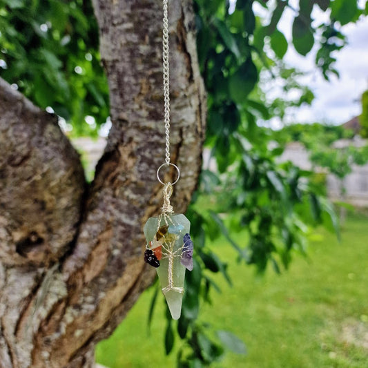 green crystal pendulum with wire-wrapped Tree of Life and chakra stones for energy work