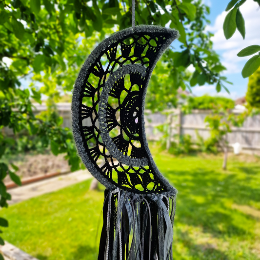 Handmade crochet Moon dreamcatcher with black and silver/grey fringe, perfect for boho wall décor and nursery spaces.