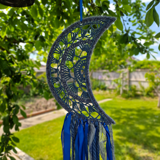 Handmade crochet Moon dreamcatcher with blue and silver ribbons and fringe, perfect for boho wall décor and nursery spaces.
