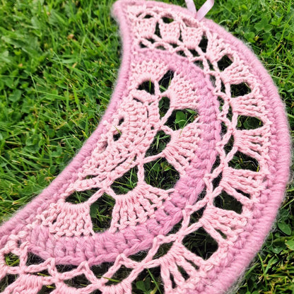 Handmade crochet Moon dreamcatcher with pink ribbons and fringe, perfect for boho wall decor and nursery spaces.