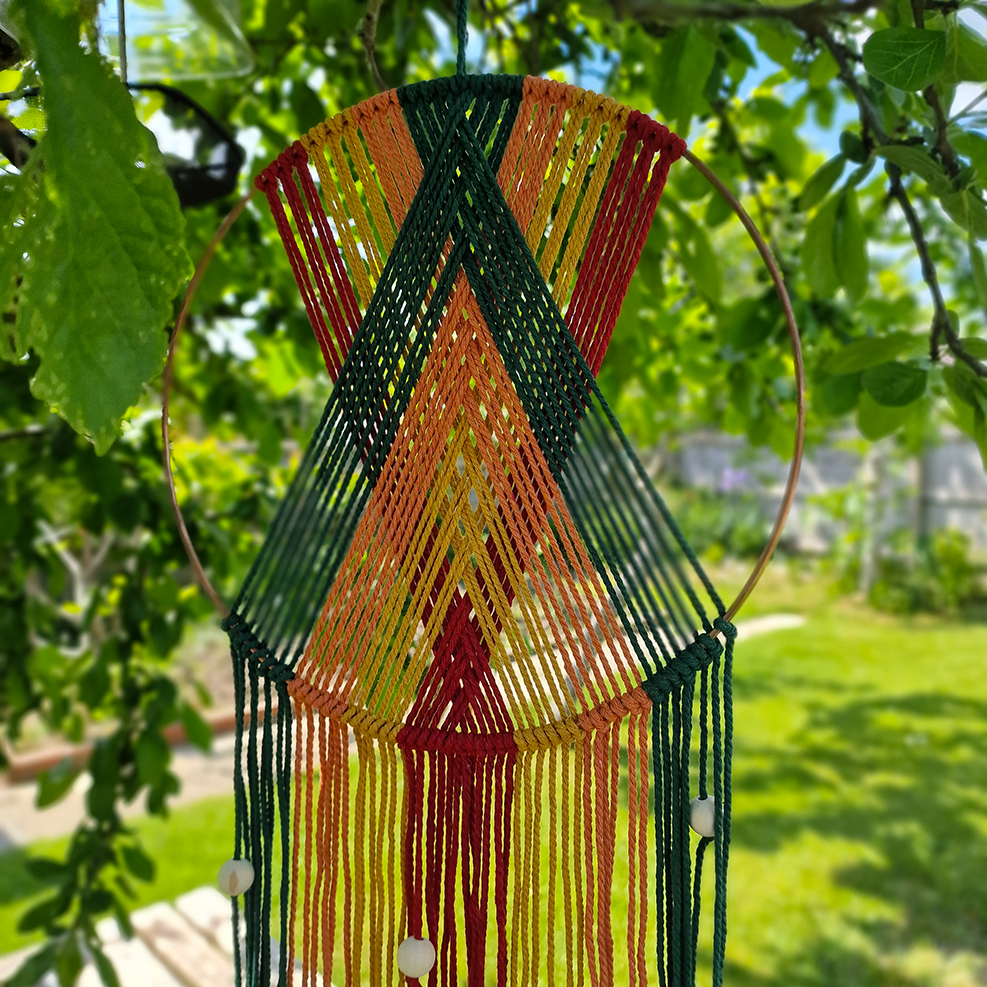 Handcrafted geometric macramé wall hanging in Autumnal colours (Red, Yellow, Orange and Green) with beads for boho décor