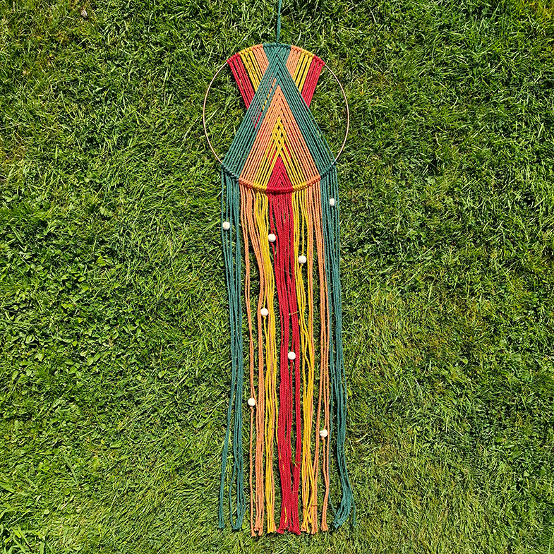 Handcrafted geometric macramé wall hanging in Autumnal colours (Red, Yellow, Orange and Green) with beads for boho décor