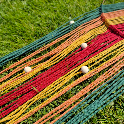Handcrafted geometric macramé wall hanging in Autumnal colours (Red, Yellow, Orange and Green) with beads for boho décor