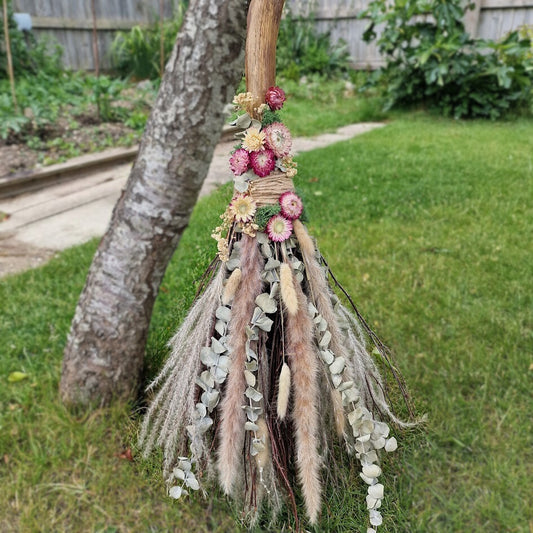 Rustic handmade Pagan witch’s broom with Citrine crystal in the handle, adorned with dried flowers, eucalyptus, and natural twigs. 